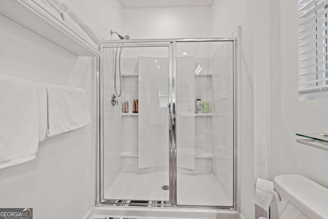 bathroom with toilet and walk in shower