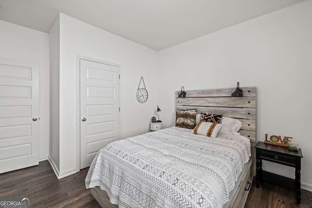 bedroom with dark hardwood / wood-style floors