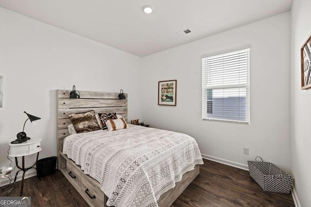 bedroom with dark wood-type flooring