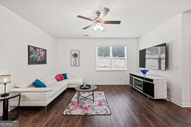 living room featuring ceiling fan and dark hardwood / wood-style floors