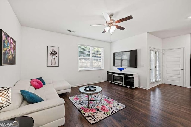 living room with ceiling fan and dark hardwood / wood-style flooring