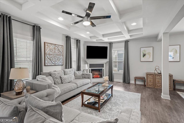 living room with hardwood / wood-style flooring, ceiling fan, coffered ceiling, and beam ceiling