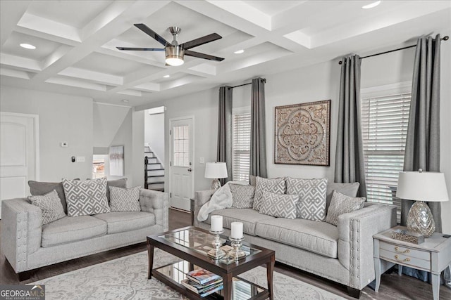 living room featuring wood-type flooring, coffered ceiling, and beam ceiling