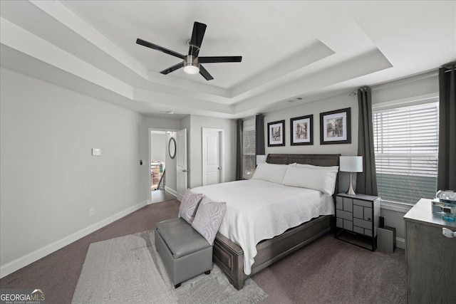 bedroom featuring carpet flooring, ceiling fan, and a tray ceiling