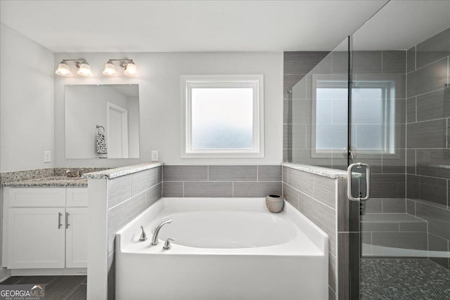 bathroom featuring vanity and separate shower and tub