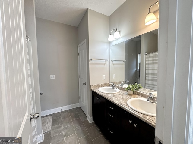 bathroom featuring vanity and a textured ceiling