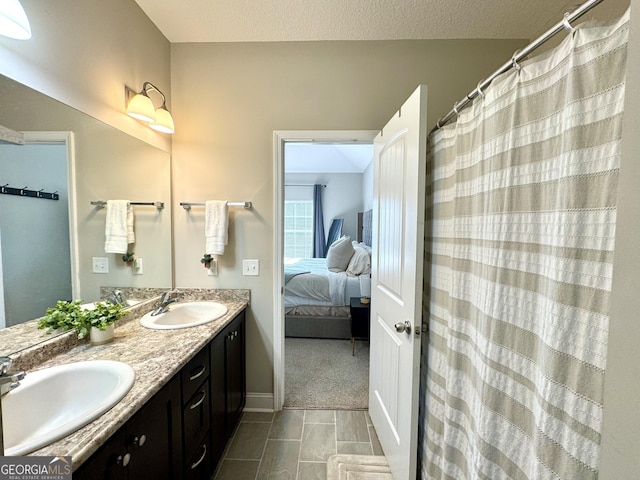 bathroom with vanity and a textured ceiling