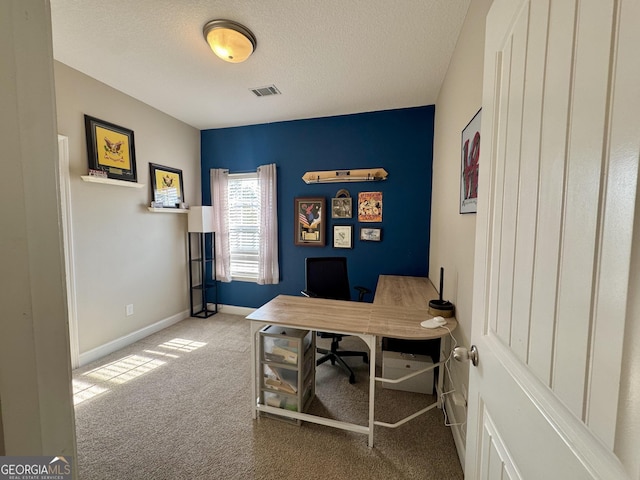 office featuring carpet floors and a textured ceiling