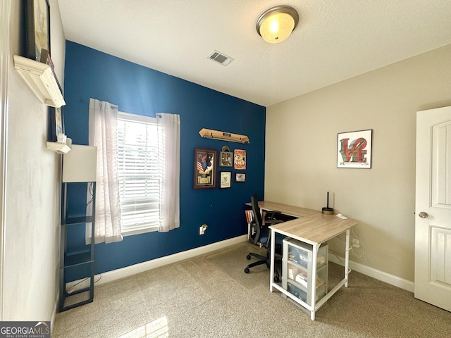 carpeted office space featuring a textured ceiling