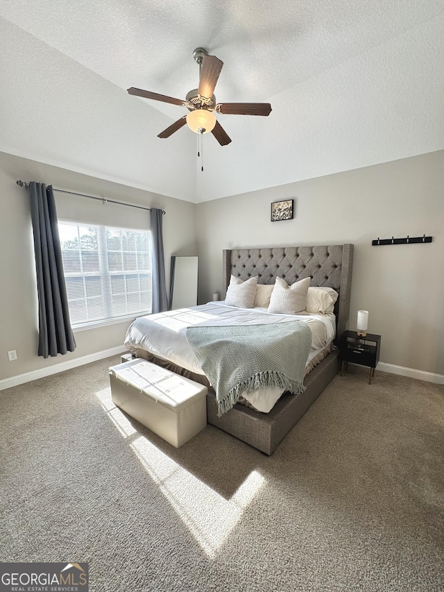 bedroom featuring ceiling fan, carpet, lofted ceiling, and a textured ceiling