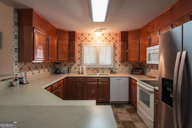 kitchen with sink, backsplash, and white appliances