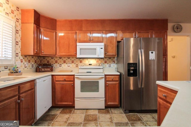 kitchen featuring white appliances and sink