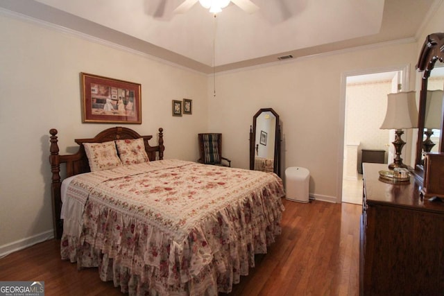 bedroom with crown molding, dark wood-type flooring, and ceiling fan