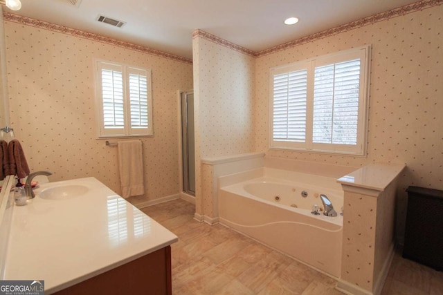 bathroom with vanity and shower with separate bathtub