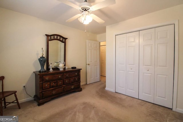 bedroom featuring light carpet, a closet, and ceiling fan