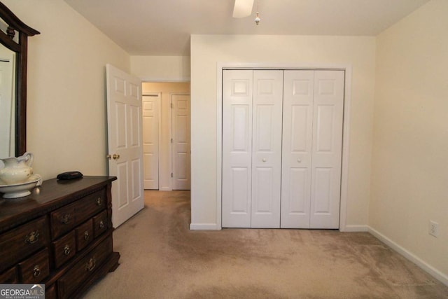 bedroom featuring light carpet and a closet