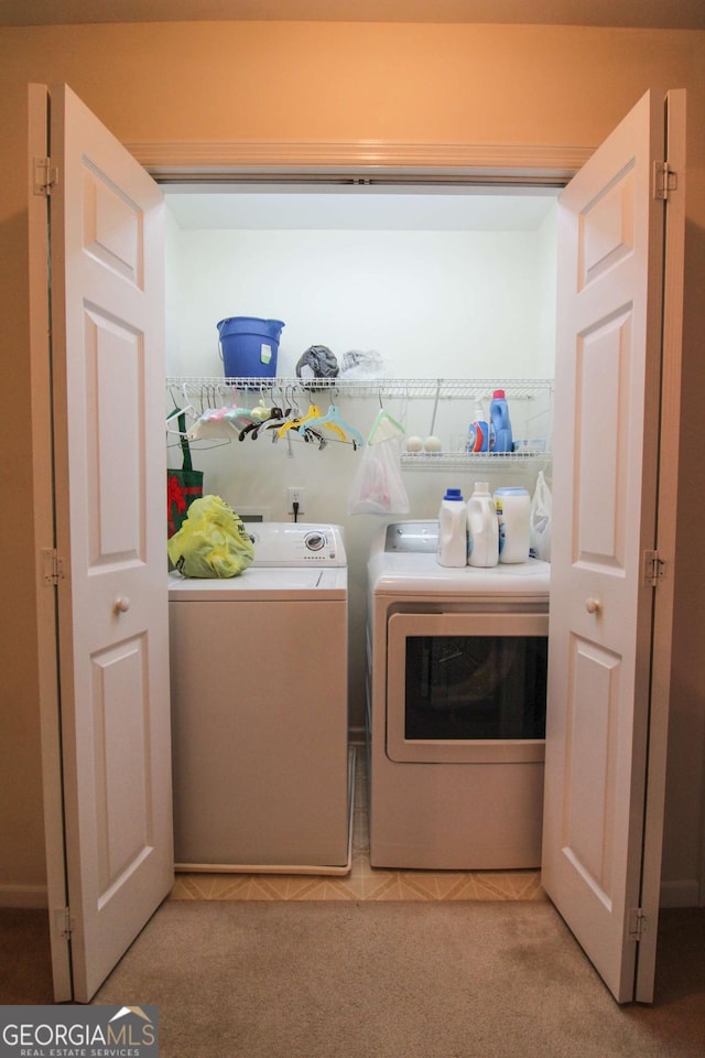 laundry room with light carpet and washing machine and clothes dryer