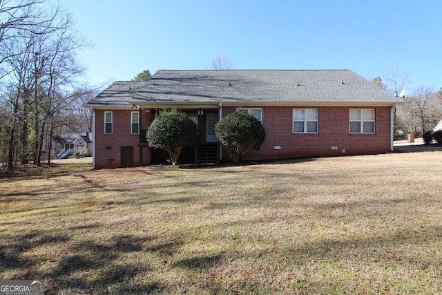 back of property featuring a yard