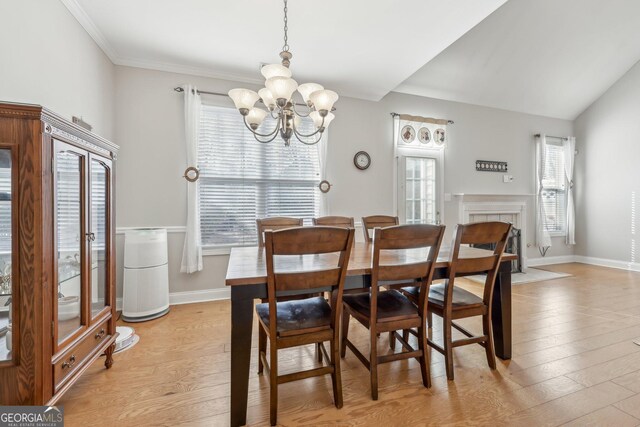 living room featuring ceiling fan, wood-type flooring, a fireplace, and high vaulted ceiling