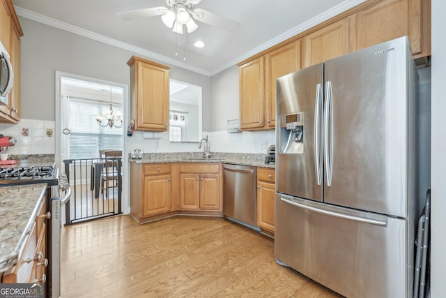 kitchen featuring sink, crown molding, light hardwood / wood-style flooring, and appliances with stainless steel finishes