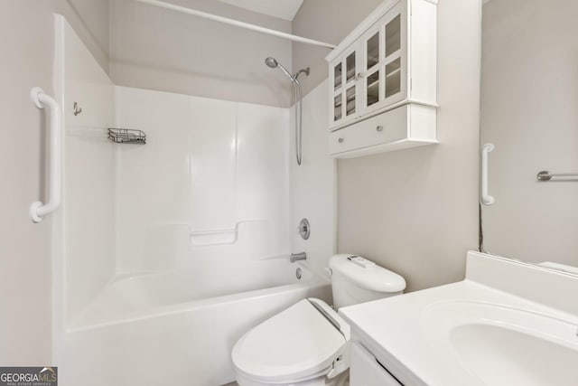 full bathroom featuring washtub / shower combination, vanity, and toilet