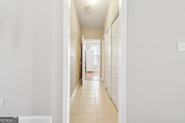 corridor featuring light tile patterned floors