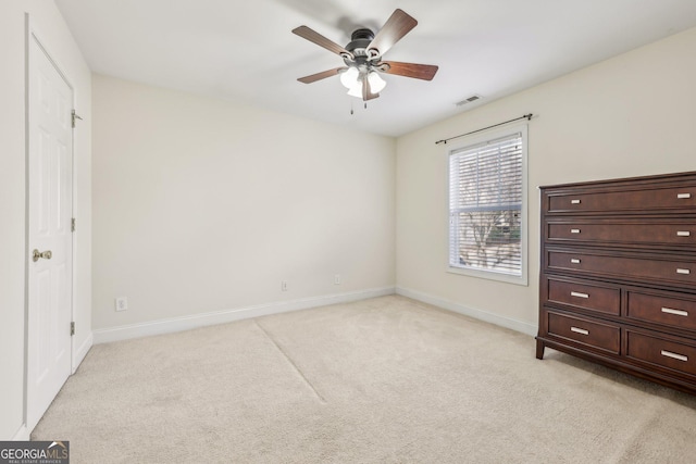 unfurnished bedroom with light colored carpet and ceiling fan