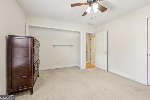 unfurnished bedroom with light colored carpet and ceiling fan