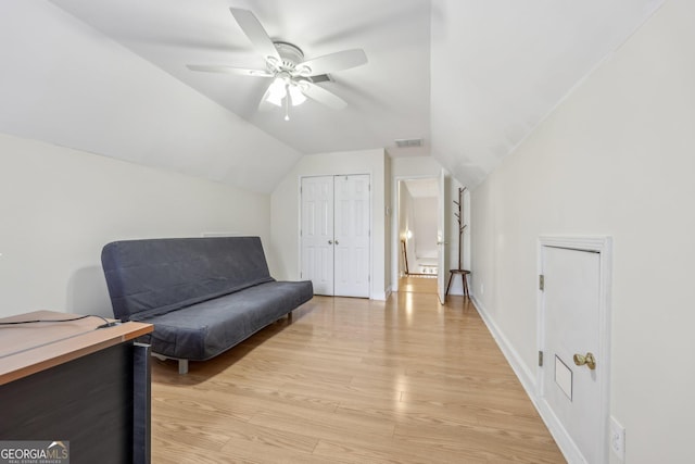 sitting room with vaulted ceiling, ceiling fan, and light wood-type flooring