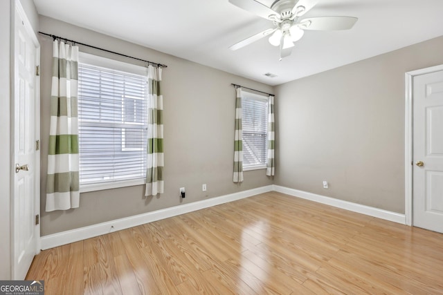 empty room with light hardwood / wood-style flooring and ceiling fan