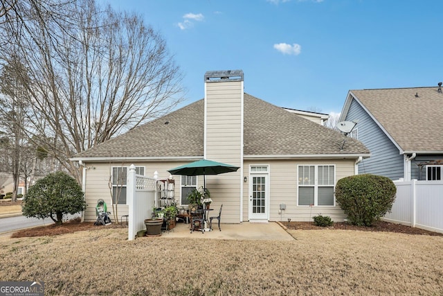 rear view of house featuring a yard and a patio area