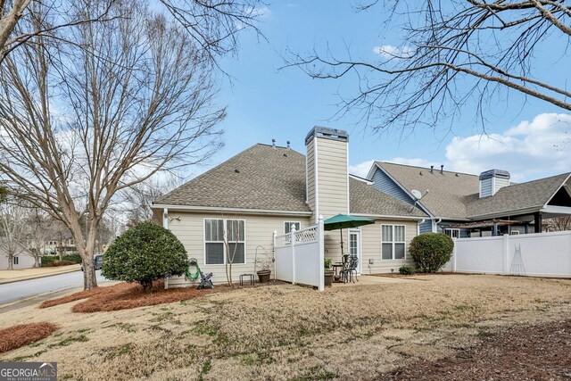 rear view of property with a yard and a patio