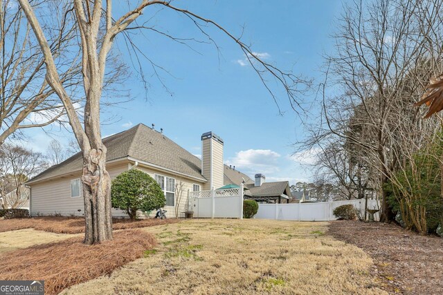 back of house featuring a yard and a patio area