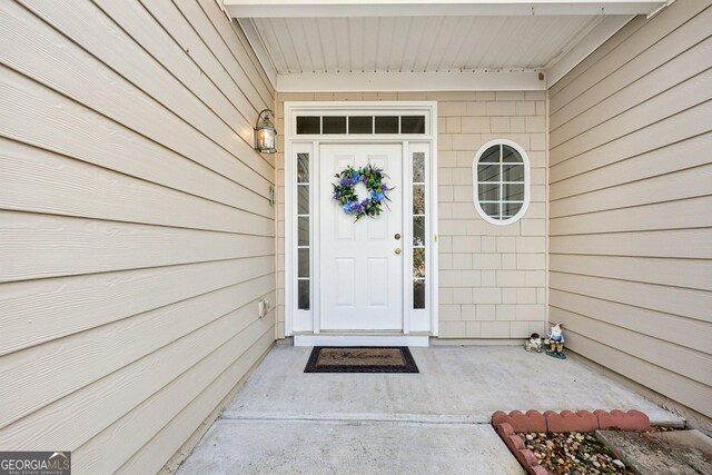 view of exterior entry with a garage