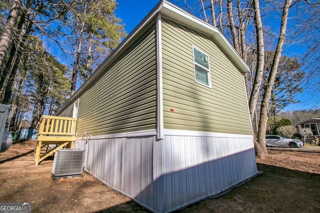 view of side of home with central AC