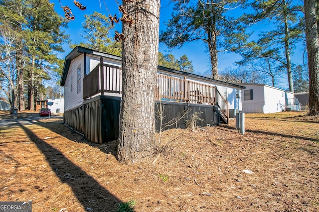 view of property exterior with a deck