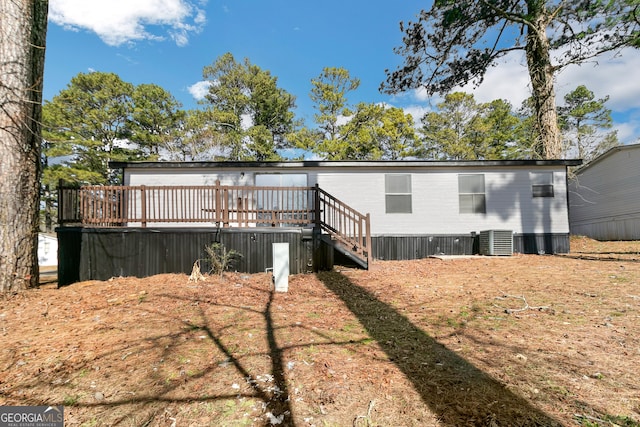 back of house with a wooden deck and central AC