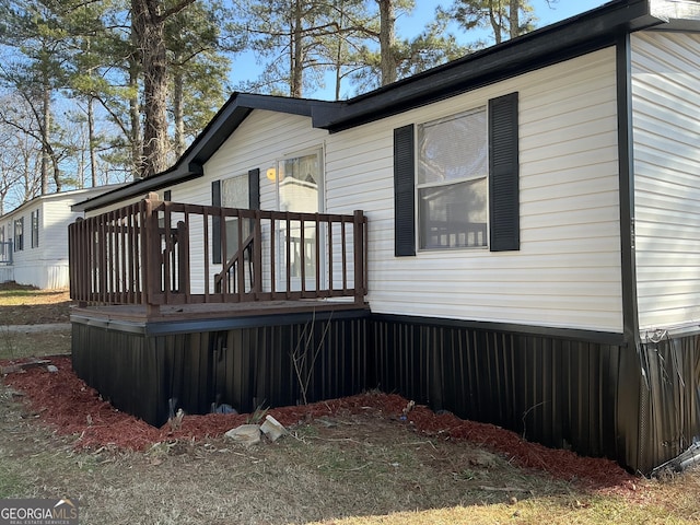 view of side of home with a wooden deck