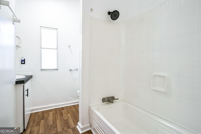 full bathroom featuring vanity, wood-type flooring, shower / bathtub combination, and toilet