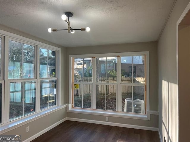 unfurnished sunroom featuring an inviting chandelier