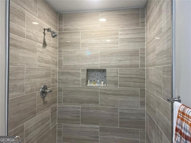 bathroom with a tile shower