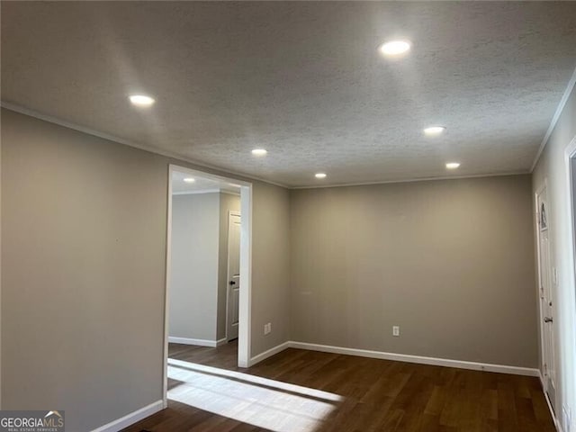 unfurnished room with dark wood-type flooring, ornamental molding, and a textured ceiling