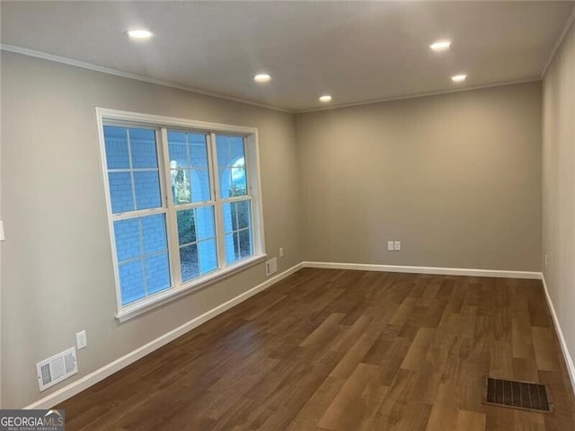 unfurnished room with crown molding and dark wood-type flooring