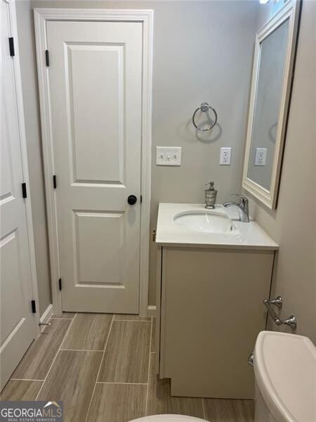 bathroom featuring vanity and toilet