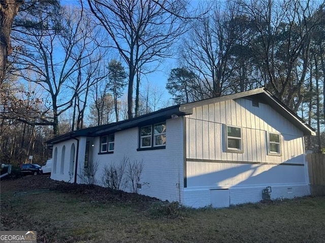 view of side of home featuring a yard