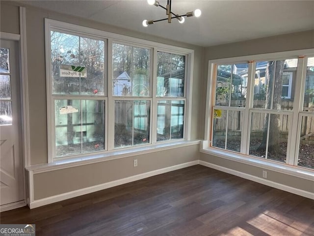 unfurnished sunroom featuring an inviting chandelier