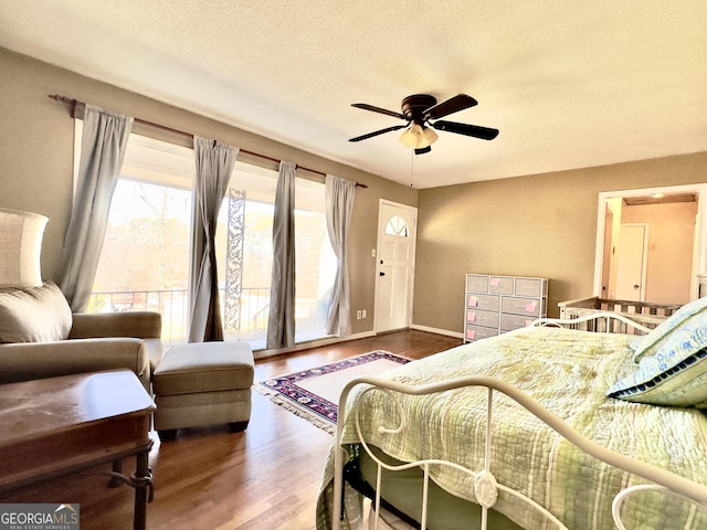 bedroom with hardwood / wood-style floors and a textured ceiling