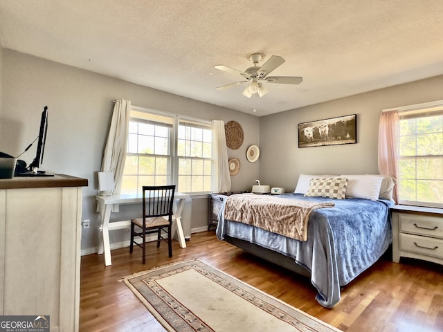 bedroom featuring a textured ceiling and dark hardwood / wood-style flooring