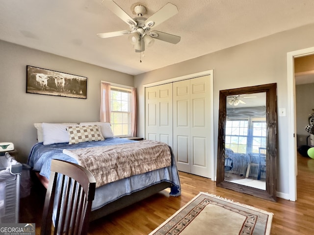 bedroom featuring a closet, ceiling fan, and light hardwood / wood-style flooring