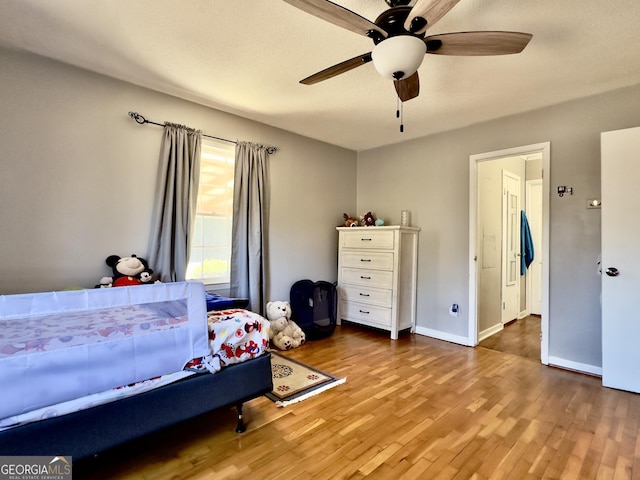 bedroom with ceiling fan and wood-type flooring